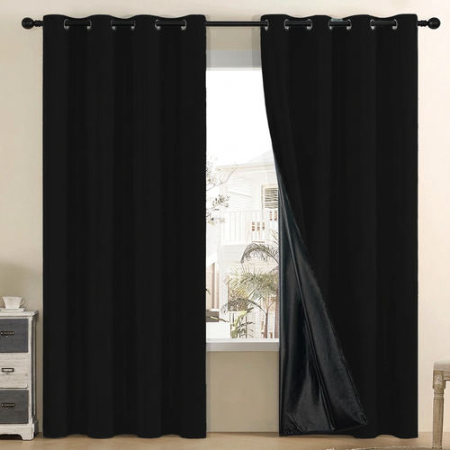 Black grommet-top curtains beside a window